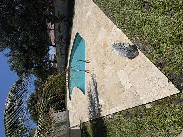 Travertine Pool Deck Cleaning & Polymeric Sand Joint Restoration in North Palm Beach, FL